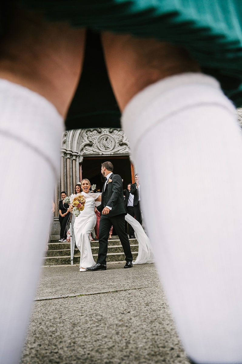 A Wedding Couple photographed under a kilt